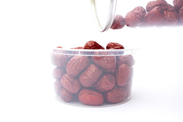 Red jujubes isolated on white background. Dried jujubes, also known as red dates, are a good source of fiber, which aids digestion and can help with weight management.