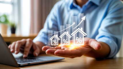 A man using a laptop presents a rising graph of house icons with percentage symbols, indicating real estate investment growth