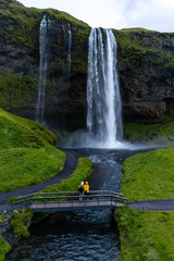 Nestled in Icelands stunning landscape, Seljalandsfoss captivates visitors with its plunging waters...