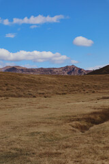 Volcanic Landscape with Smoke Rising from Mount Aso under Blue Sky in Japan