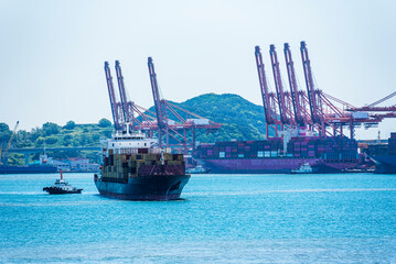 Port of Busan, South Korea. Panorama view on the ships and gantry cranes in the container terminal.