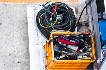 Diving equipment is organized on a dock, ready for underwater use.