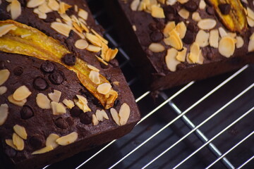Overhead view of fresh homemade banana bread cooling on a shelf, showing close up details of banana bread slices with chocolate chunks, Banana bread or cake for breakfast and celebration cakes.