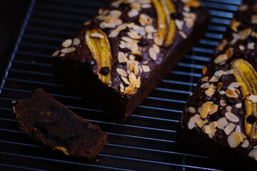 Overhead view of fresh homemade banana bread cooling on a shelf, showing close up details of banana bread slices with chocolate chunks, Banana bread or cake for breakfast and celebration cakes.
