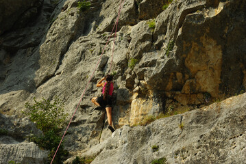An interesting cliff in the province of Pescara, Abruzzo with compact limestone , equipped for free climbing . A novice climber  can be see on bear wall