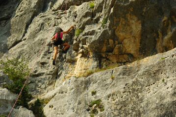An interesting cliff in the province of Pescara, Abruzzo with compact limestone , equipped for free climbing . A novice climber  can be see on bear wall