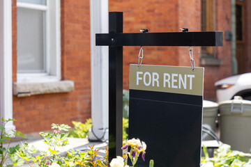 For rent sign in front of a residential building. Real estate business.