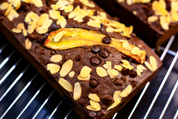 Overhead view of fresh homemade banana bread cooling on a shelf, showing close up details of banana bread slices with chocolate chunks, Banana bread or cake for breakfast and celebration cakes.