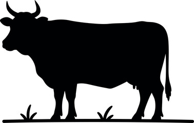 Black silhouette of a cow standing in grass