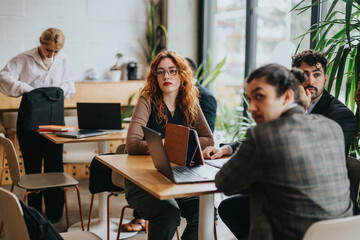A team of people discusses and collaborates in a rustic co working cafe, highlighting teamwork and...