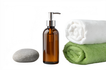 Amber glass liquid soap dispenser with rolled towels and smooth stone isolated on transparent background