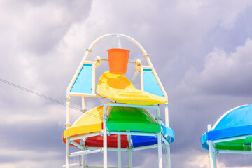 A colorful structure with a bucket on top