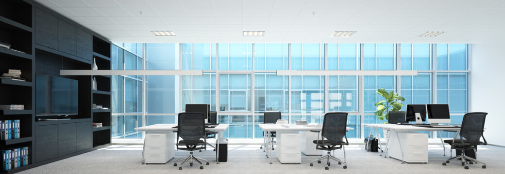 Modern office interior with empty desks chairs and computers in a spacious room. Contemporary workspace design for corporate business.