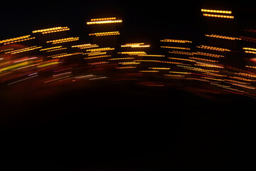 Defocused background with the image of light effects. Lights in dynamic movement in a circle on a black background.