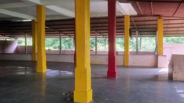 Colorful pillars of a Hindu temple structure located in South India, likely setting of place of worship, a religious or spiritual site, possibly a stone temple or a shrine