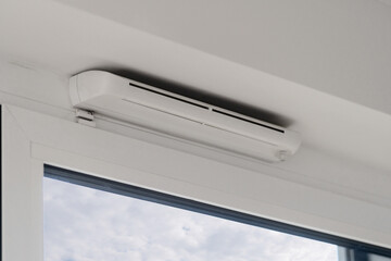 Stylish white PVC window frame with double insulated glass in modern living room