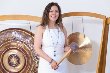 Woman Playing Singing Bowl During Sound Meditation Session