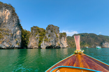 Scenic phang nga bay Thailand with limestone cliffs and traditional boat on clear waters