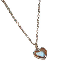 Heart-shaped transparent pendant jewelry showcase close-up view elegant display in natural light