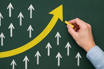 Strategic Leadership Breakthrough Hand Drawing of Yellow Arrow Among White Arrows on Chalkboard in Classroom Setting
