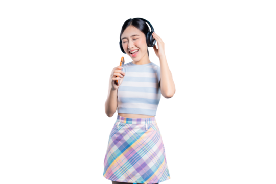 A happy young Asian woman with headphones, closing her eyes and singing along to her favorite song on her phone.
on png 