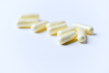 Alpha-lipoic acid capsules. Paper background. Soft focus. Close up. Copy space.	