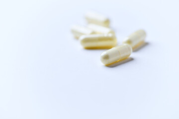 Alpha-lipoic acid capsules. Paper background. Soft focus. Close up. Copy space.	