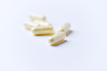Alpha-lipoic acid capsules. Paper background. Soft focus. Close up. Copy space.	