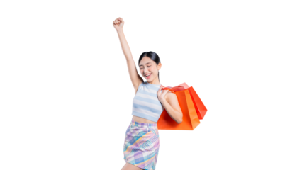 An ecstatic young Asian woman cheering with a raised fist, holding shopping bags to celebrate a great sale or purchase.
on png 