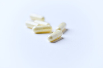 Alpha-lipoic acid capsules. Paper background. Soft focus. Close up. Copy space.	