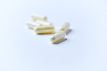 Alpha-lipoic acid capsules. Paper background. Soft focus. Close up. Copy space.	