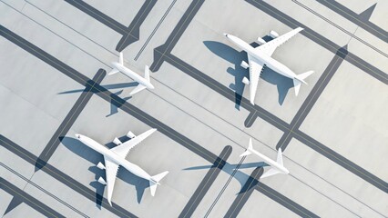 Aerial view of four white airplanes parked on a concrete surface with black lines marking the area