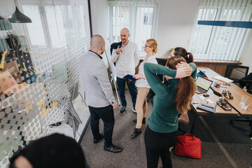 A team of colleagues engages in a collaborative discussion in a contemporary office space,...