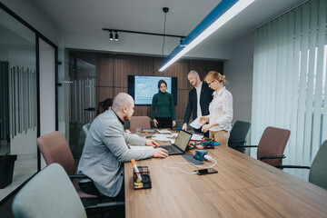 A team of professionals collaborating on business strategies inside a modern conference room...