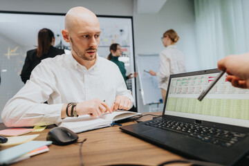 Office setting featuring associates engaged in discussions and reviewing documentation, showcasing...