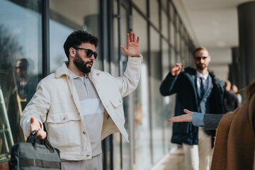 Two fashionable men exchange a friendly greeting outdoors, reflecting modern urban lifestyle.