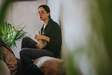 A young student sits comfortably enjoying breakfast during a school break. The peaceful atmosphere...