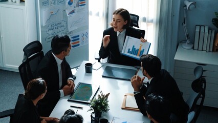 Top view of professional executive manager show increasing sales chart to diverse team while group...