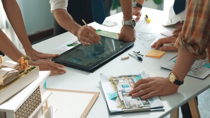 Close up of smart business team hand working together to plan design while looking at project plan...