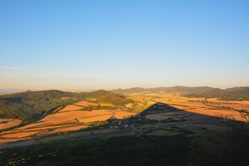 Morning Mountain View Shadow over Golden Summer Fields and Blue Sky