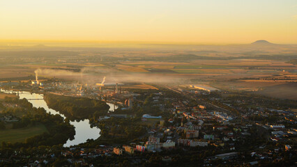 Gold Morning Light over Misty Czech Lowland with Industrial Town and Chemical Plant Smog
