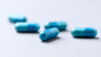 Amino acids capsules on bright background. Soft focus. Close up. Copy space.	