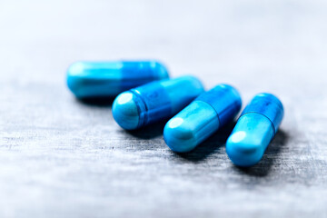 Amino acids capsules on bright wooden background. Soft focus. Close up. Copy space.	