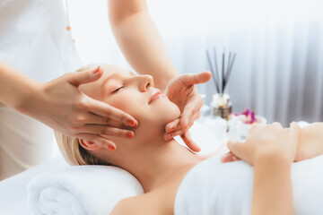 Caucasian woman enjoying relaxing anti-stress head massage and pampering facial beauty skin...