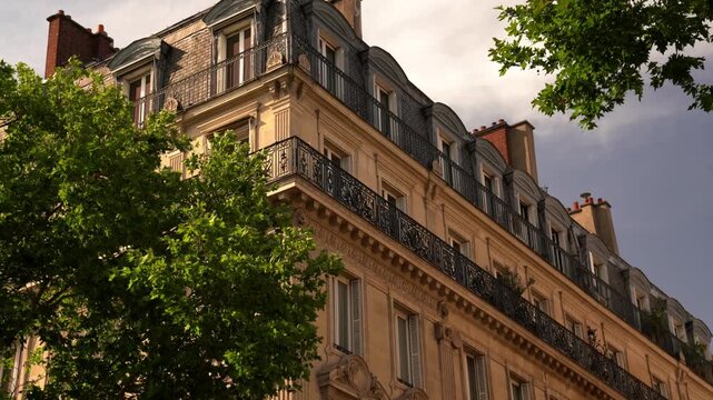 Classic Parisian apartment buildings with elegant balconies and stone facades. Iconic French architecture, ideal for real estate, travel, and lifestyle footage.
