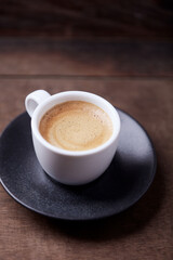 Fototapeta premium Cup of coffee on wooden background. Close up 