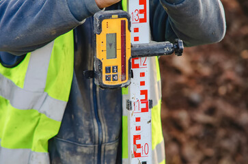 Close-up of Construction worker using laser level to check level on construction site