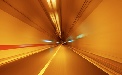A dynamic, motion-blurred shot from inside a brightly lit tunnel, conveying speed and movement.