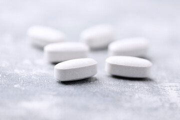 Amino acids tablets on wooden background. Soft focus. Close up	