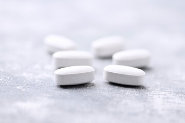 Amino acids tablets on wooden background. Soft focus. Close up	